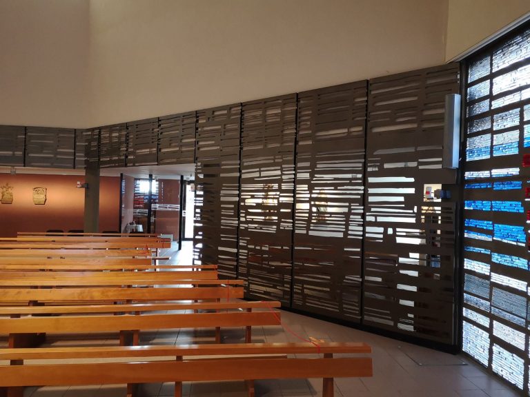 Blick ins Innere einer modernen Kirche mit individuell gefertigter Metalltrennwand.